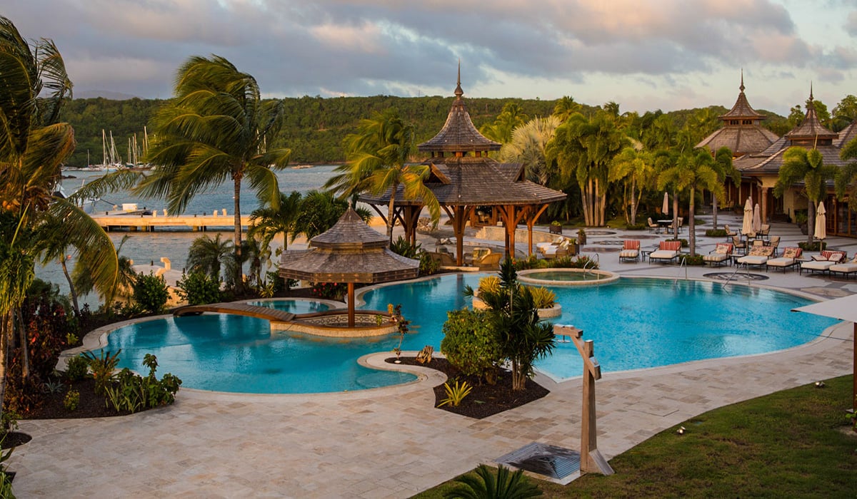 Calivigny Island Caribbean resort view of pool and palm trees
