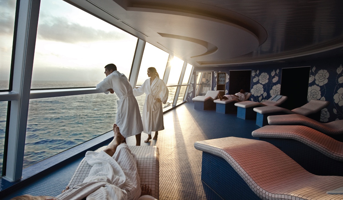 Canyon Ranch Celebrity Cruise spa couple in robes looking out window over ocean