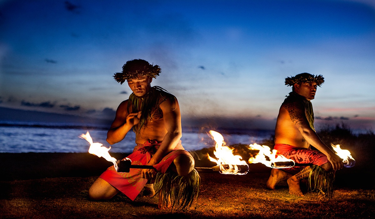 Hawaiian fire dancers in front of sunset