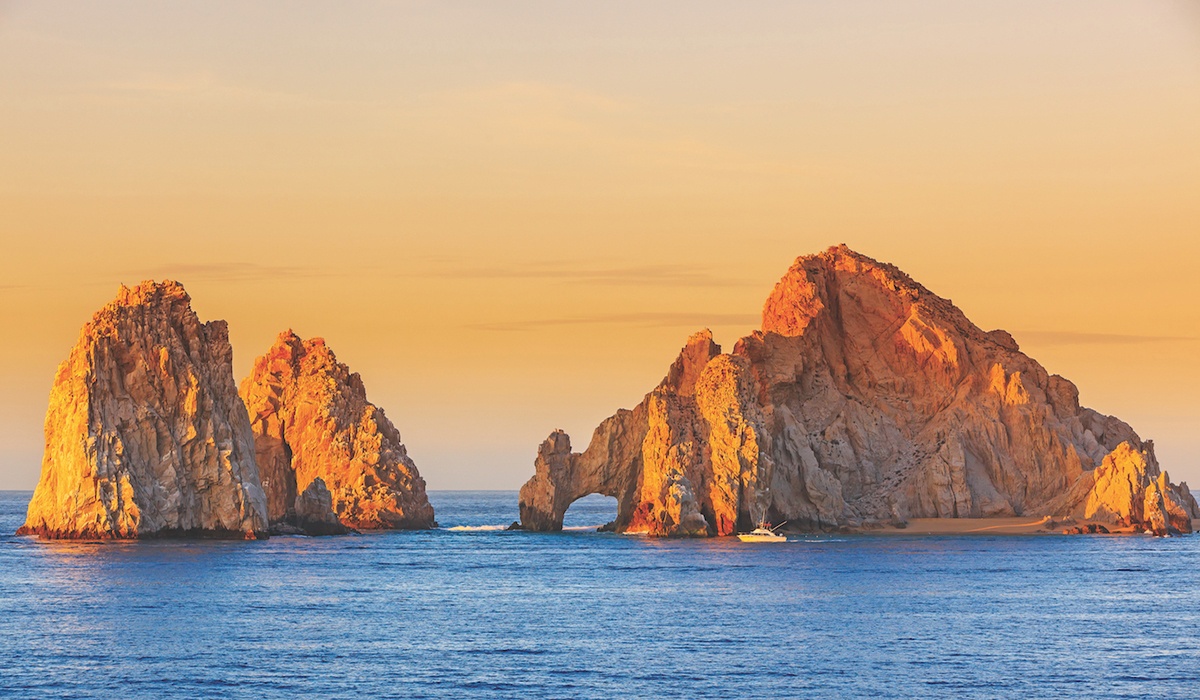 Los Cabos islands at sea orange sunset