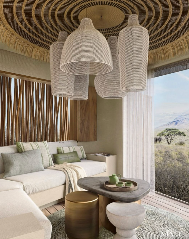 Nature-inspired sitting area features woven lighting, soft seating, and expansive windows with views of the savanna.