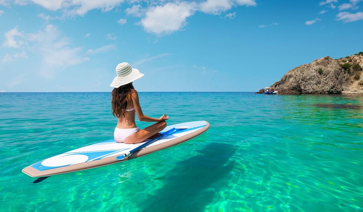 Girl on paddle board in tropical waters