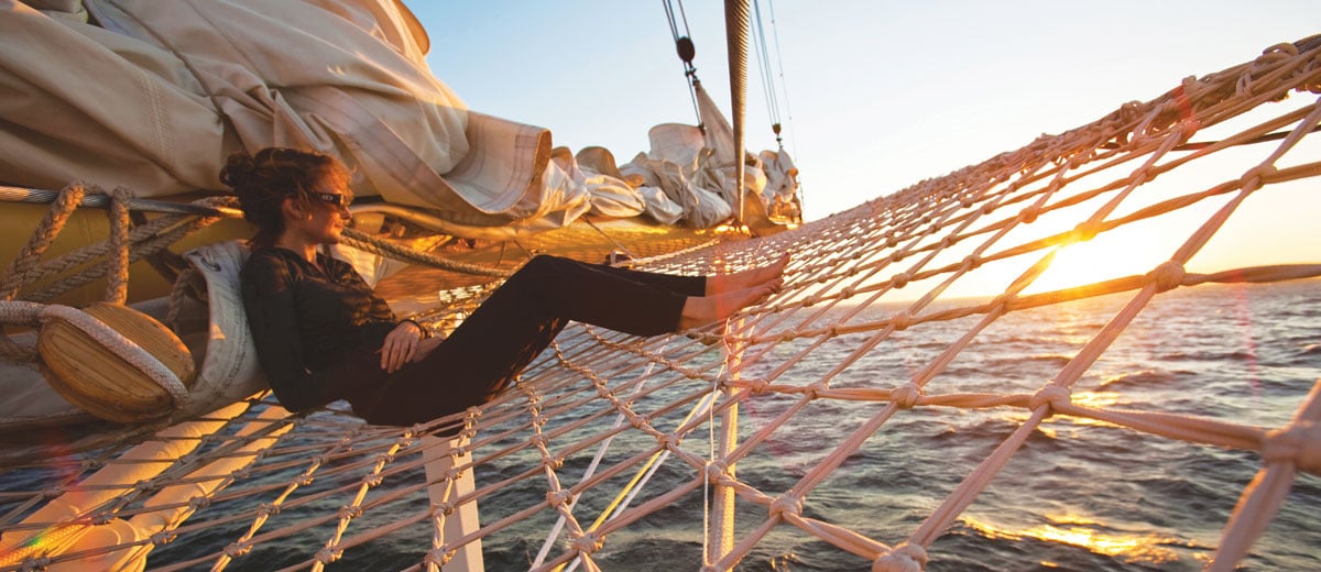 girl in net of ship at sea