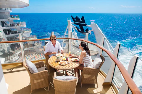 Couple enjoying breakfast on balcony
