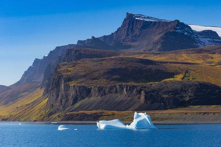 volcanic cliffs and a small Iceberg Baffin Bay