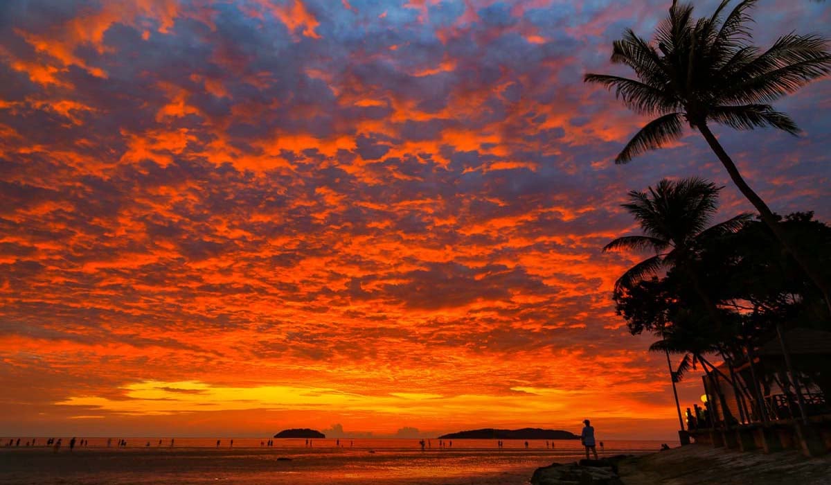 Kota Kinabalu Orange Sunset on beach with palm trees
