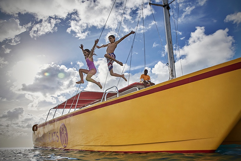 kids jumping off boat