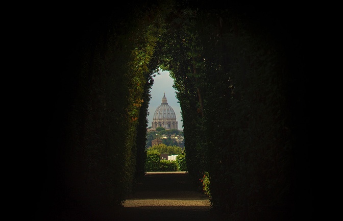 Vatican City in Rome peephole through shrubs